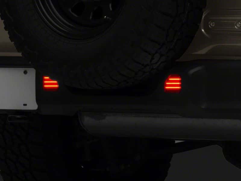 Raxiom — Raxiom 18-23 Jeep Wrangler JL Moab Rubicon Sahara Axial LED Rear Bumper Reflector Lights- Smoked
Lights - view 4